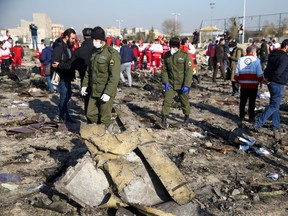 Security officers and Red Crescent workers are seen at the site where the Ukraine International Airlines plane crashed after take-off from Iran's Imam Khomeini airport, on the outskirts of Tehran, Iran January 8, 2020. Nazanin Tabatabaee/WANA (West Asia News Agency) via REUTERS