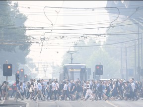 Morning commuters are seen through smoke haze from bushfires in Melbourne, Australia, Jan. 14, 2020. (AAP Image/Erik Anderson/via REUTERS)