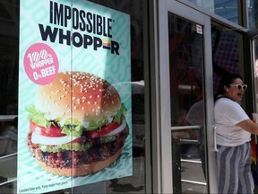 A sign advertising the soy-based Impossible Whopper is seen outside a Burger King in New York, August 8, 2019. (REUTERS/Shannon Stapleton/File Photo)