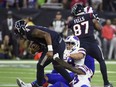 Houston Texans quarterback Deshaun Watson (4) breaks away from Buffalo Bills' Siran Neal (33) and Matt Milano (58) to throw a pass to setup the game-winning field goal during overtime of an NFL wild-card playoff football game Saturday, Jan. 4, 2020, in Houston. The Texans won 22-19 in overtime. (AP Photo/Eric Christian Smith)