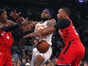 New York Knicks centre Mitchell Robinson (middle) battles Toronto Raptors forward Rondae Hollis-Jefferson (left) and guard Norman Powell for a rebound during Friday's game. (USA TODAY SPORTS)