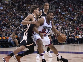 Raptors guard Kyle Lowry dribbles the ball as Hawks guard Trae Young (left) defends during Tuesday's game. (USA TODAY SPORTS)