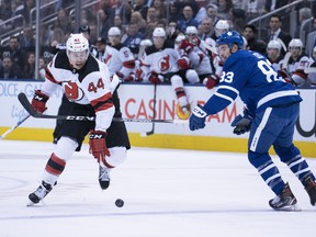 Devils’ Miles Wood (left) moves in on Maple Leafs defenceman Cody Ceci at Scotiabank Arena last night. Nick Turchiaro/USA TODAy