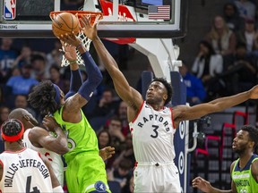 Minnesota Timberwolves forward Robert Covington drives to the basket and shoots the ball over Toronto Raptors forward OG Anunoby in the first half at Target Center. J