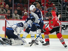 Winnipeg Jets goaltender Connor Hellebuyck makes a save on a shot from Chicago Blackhawks centre Jonathan Toews during the third period at the United Center.