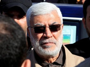 Abu Mahdi al-Muhandis, a commander in the Popular Mobilization Forces, attends a funeral procession of Hashd al-Shaabi (paramilitary forces) members, who were killed by U.S. air strikes in Qaim district, at the Green Zone in Baghdad, Iraq, Dec. 31, 2019.