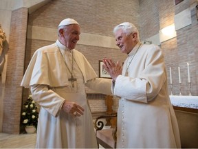 This handout picture released by the Vatican press office on November 19, 2016 shows Pope Francis (L) and Pope emeritus Benedict XVI during a meeting with newly nominated cardinals after a consistory on November 19, 2016 at the Vatican.
