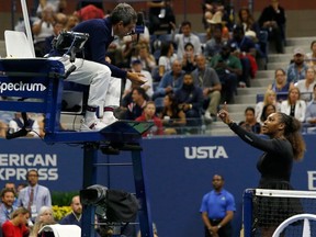 In this file photo taken on September 8, 2018 Serena Williams of the US argues with chair umpire Carlos Ramos while playing Naomi Osaka of Japan during their 2018 US Open women's singles final match in New York.