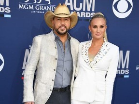 US singer Jason Aldean (L) and wife US cheerleader Brittany Kerr arrive for the 54th Academy of Country Music Awards on April 7, 2019, at the MGM Grand Garden Arena in Las Vegas, Nevada.