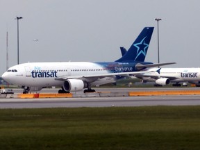 In this file photo taken on June 1, 2018, Air Transat jets prepare to take off at at Montreal's Pierre Elliott Trudeau International Airport.