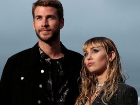 In this file photo taken on June 6, 2019, US singer Miley Cyrus and husband Australian actor Liam Hemsworth arrive for the Saint Laurent Men's Spring-Summer 2020 runway show in Malibu, California.