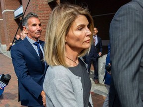 In this file photo taken on August 27, 2019, actress Lori Loughlin and husband Mossimo Giannulli exit the Boston Federal Court house after a pre-trial hearing with Magistrate Judge Kelley at the John Joseph Moakley US Courthouse in Boston.
