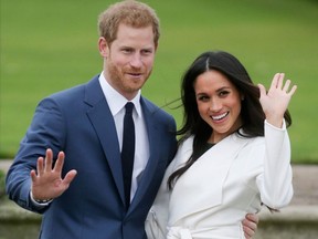 In this file photo taken on November 27, 2017 Britain's Prince Harry and his fiancée US actress Meghan Markle pose for a photograph in the Sunken Garden at Kensington Palace in west London, following the announcement of their engagement.