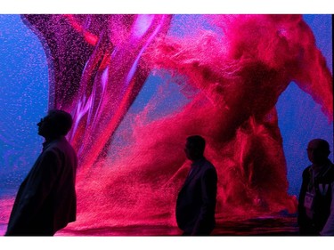 People walk past the SK Telecom exhibit during the 2020 Consumer Electronics Show (CES) in Las Vegas on Jan. 8, 2020.