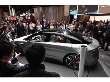 Attendees view the Sony Vision-S electric concept car Jan. 8, 2020, at the 2020 Consumer Electronics Show (CES) in Las Vegas.