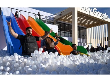 Attendees play on the Google slide, Jan. 8, 2020 at the 2020 Consumer Electronics Show (CES) in Las Vegas.