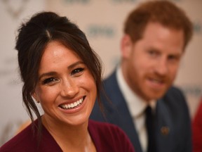 In this file photo taken on October 25, 2019 Prince Harry, Duke of Sussex (R) and Meghan, Duchess of Sussex attend a roundtable discussion on gender equality with The Queens Commonwealth Trust (QCT) and One Young World at Windsor Castle in Windsor.  (Photo by JEREMY SELWYN/POOL/AFP via Getty Images)