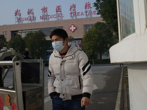 A man leaves the Wuhan Medical Treatment Centre, where a man who died from a respiratory illness was confined, in the city of Wuhan, Hubei province, on January 12, 2020. A 61-year-old man has become the first person to die in China from a respiratory illness believed caused by a new virus from the same family as SARS, which claimed hundreds of lives more than a decade ago, authorities said.