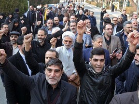 Supporters of the Basij, a militia loyal to the Islamic republic's establishment, chant anti-US slogans during a memorial for the victims of the Ukraine plane crash in University of Tehran on January 14, 2020.