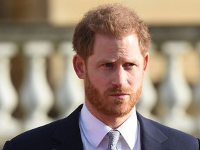 Britain's Prince Harry, Duke of Sussex gestures as he watches children play rugby league prior to the draw for the Rugby League World Cup 2021 at Buckingham Palace in London on January 16, 2019.