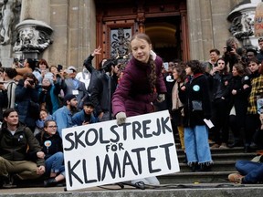 17-year-old Swedish climate activist Greta Thunberg holds a placard reading "School strike for Climate" during a climate strike against governmental inaction towards climate breakdown and environmental pollution in Lausanne, on January 17, 2020.