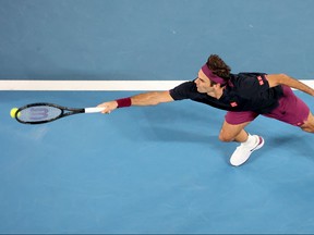 Roger Federer hits a return against Filip Krajinovic during their men's singles match on day three of the Australian Open tennis tournament in Melbourne on Jan. 22, 2020. (DAVID GRAY/AFP via Getty Images)