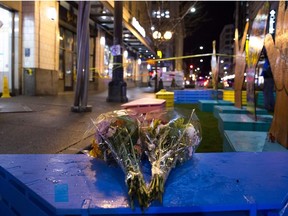 Bouquets of flowers are pictured near the scene of a shooting that left one person dead and seven injured, including a child, in downtown Seattle, Washington on January 22, 2020. -