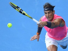 Spain's Rafael Nadal hits a return against Australia's Nick Kyrgios during their men's singles match on day eight of the Australian Open tennis tournament in Melbourne on January 27, 2020.