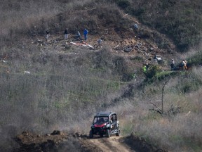 Investigators work at the scene of a helicopter crash in Calabasas, California on Monday, January 27, 2020 that killed 9 people included former Los Angeles Laker star and NBA legend Kobe Bryant and his daughter Gianna Maria.