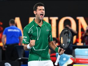 Serbia's Novak Djokovic celebrates after beating Switzerland's Roger Federer during their men's singles semifinal match on day eleven of the Australian Open tennis tournament in Melbourne on Jan. 30, 2020. (WILLIAM WEST/AFP via Getty Images)