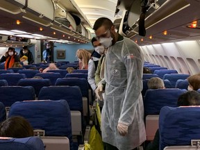 French citizens arrive and settle aboard of an evacuation plane with destination southeastern France, before departure from Wuhan Airport (WUH), China, on the night between January 30, 2020 and January 31, 2020, as they are repatriated from the coronavirus hot zone.