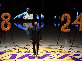 US singer Usher (C) performs "Amazing Grace" in honor of NBA legend Kobe Bryant, after he was killed last weekend in a helicopter accident, ahead of a game between Los Angeles Lakers and Portland Trail Blazers, at the Staples Center in Los Angeles, California on January 31, 2020.