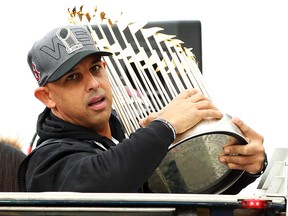 Boston Red Sox Manager Alex Cora holds the World Series trophy during the team’s victory parade on October 31, 2018 in Boston. (Adam Glanzman/Getty Images)