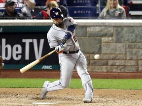 Robinson Chirinos of the Houston Astros hits a two-run home run in Game Four of the 2019 World Series on Oct. 26, 2019.