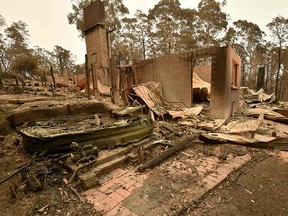 The remains of a house destroyed by a bushfire are seen outside Batemans Bay in New South Wales on January 2, 2020. (PETER PARKS/AFP via Getty Images)