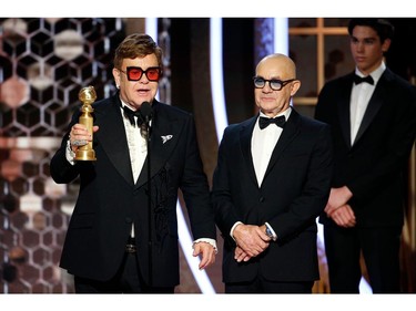 77th Golden Globe Awards - Show - Beverly Hills, California, U.S., January 5, 2020 - Elton John and Bernie Taupin accept the award for Best Original Song - Motion Picture for "I'm Gonna Love Me Again" from "Rocketman."   Paul Drinkwater/NBC Universal/Handout via REUTERS For editorial use only. Additional clearance required for commercial or promotional use, contact your local office for assistance. Any commercial or promotional use of NBCUniversal content requires NBCUniversal's prior written consent. No book publishing without prior approval. NO SALES. NO ARCHIVES. ORG XMIT: LOA202