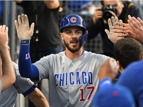 Chicago Cubs right fielder Kris Bryant is greeted after hitting a solo home run against the Los Angeles Dodgers during the third inning at Dodger Stadium.