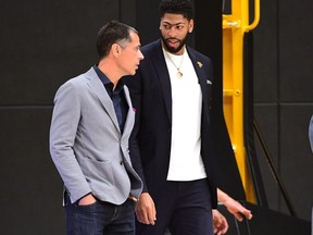 Los Angeles Lakers general manager Rob Pelinka (left) and forward/center Anthony Davis enter the gym for a press conference at the UCLA Health Training Center.