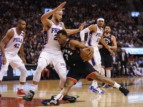 Toronto Raptors guard Kyle Lowry runs into Philadelphia 76ers guard Ben Simmons during the first half at Scotiabank Arena.