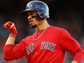 Mookie Betts of the Boston Red Sox celebrates after hitting a single during the third inning against the Baltimore Orioles at Fenway Park on Sept. 29, 2019 in Boston.