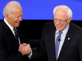Democratic 2020 U.S. presidential candidates (L-R) former vice-president Joe Biden greets Sen. Bernie Sanders (I-VT) as they take the stage for the seventh Democratic 2020 presidential debate at Drake University in Des Moines, Iowa, on Jan. 14, 2020.