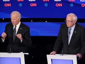 Former U.S. vice-president Joe Biden (L) speaks as Sen. Bernie Sanders (I-VT) listens during the Democratic presidential primary debate at Drake University on January 14, 2020 in Des Moines, Iowa.