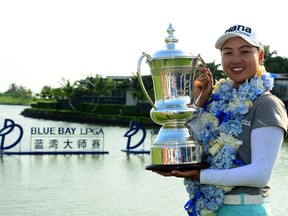 Minjee Lee poses with her trophy after winning the Blue Bay LPGA tournament at Jian Lake Blue Bay Golf Course in Sanya on China's Hainan Island on October 23, 2016. (STRINGER/AFP/Getty Images)