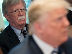 In this file photo taken on May 9, 2018, U.S. President Donald Trump speaks alongside then-national security adviser John Bolton (L) during a Cabinet Meeting in the Cabinet Room of the White House in Washington, D.C.
