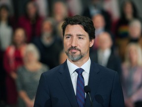 Prime Minister Justin Trudeau stands in front of his cabinet as he speaks to media during the final day of the Liberal cabinet retreat at the Fairmont Hotel in Winnipeg, Tuesday, Jan. 21, 2020.