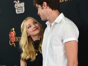 In this July 24, 2015, file photo, Dove Cameron and Ryan McCartan attend the premiere of Disney Channel's "Descendants" at Walt Disney Studios in Burbank, Calif.