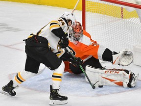 Philadelphia Flyers goaltender Carter Hart makes a save on Boston Bruins left wing Jake DeBrusk (74) during a shootout at Wells Fargo Center. (Eric Hartline-USA TODAY Sports)