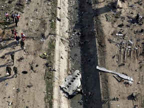 Rescue workers search the scene where a Ukrainian plane crashed in Shahedshahr, southwest of the capital Tehran, Iran on Wednesday, Jan. 8, 2020.