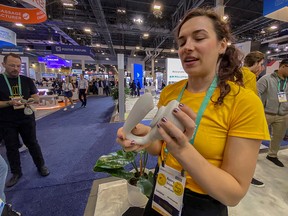 Avery Smith, an engineering assistant for Lora DiCarlo, shows the Ose dual stimulation device at the Consumer Electronics Show (CES) in Las Vegas January 9, 2020. (REUTERS/Nathan Frandino)