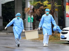 Medical staff carry a box as they walk at the Jinyintan hospital, where the patients with pneumonia caused by the new strain of coronavirus are being treated, in Wuhan, Hubei province, China January 10, 2020.